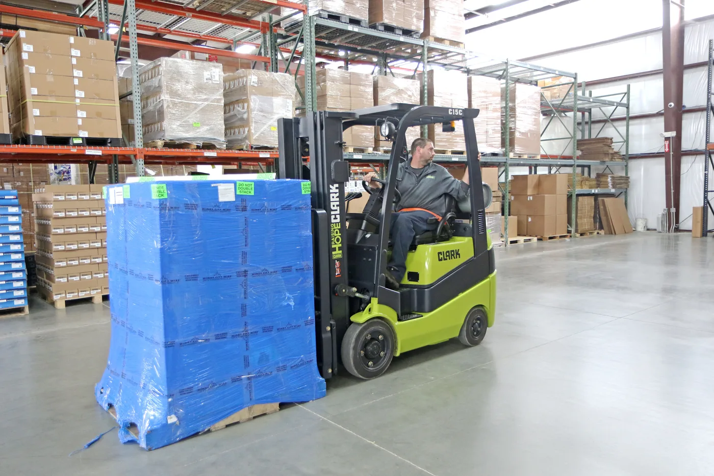 Used Clark cushion tire forklift moving a pallet in a Delaware warehouse